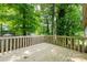 A wooden deck surrounded by tall trees, offering a private outdoor space at 1018 Autumn Ln, Hickory, NC 28602