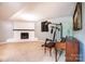 Spacious basement featuring a painted brick fireplace, exercise machine, and piano at 1018 Autumn Ln, Hickory, NC 28602