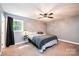 Cozy bedroom with a ceiling fan and large bright window at 1018 Autumn Ln, Hickory, NC 28602