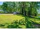 Split-level house on a large grassy lot with mature trees and a long driveway at 1018 Autumn Ln, Hickory, NC 28602