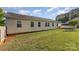 Lush backyard featuring the back of the house, a shed, and verdant green grass at 106 Rainbow Sw St, Concord, NC 28025