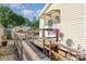 Charming backyard entrance with ramp, wooden deck, and colorful hanging flower basket at 106 Rainbow Sw St, Concord, NC 28025