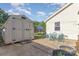 Spacious backyard featuring a storage shed, patio area, and lush green lawn at 106 Rainbow Sw St, Concord, NC 28025