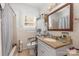 Bathroom with shower/tub combination, neutral tile, and single sink vanity at 106 Rainbow Sw St, Concord, NC 28025