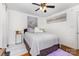 Bright bedroom with hardwood floors, ceiling fan, and a plush bed with gray comforter at 106 Rainbow Sw St, Concord, NC 28025