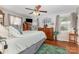 Bright bedroom with ceiling fan, hard wood floors, and matching wood furnishings at 106 Rainbow Sw St, Concord, NC 28025