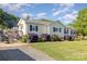 Attractive home with a landscaped yard, side patio, and cozy porch swing at 106 Rainbow Sw St, Concord, NC 28025