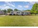 Well-kept home featuring a manicured lawn, charming exterior details, and a porch swing at 106 Rainbow Sw St, Concord, NC 28025