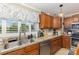 Well-lit kitchen with stainless steel appliances, double sinks, and custom cabinetry at 106 Rainbow Sw St, Concord, NC 28025