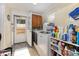 Well-lit laundry room featuring modern washer, dryer, storage cabinets, and detergent shelves at 106 Rainbow Sw St, Concord, NC 28025