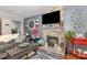 Comfortable living room features a fireplace, hardwood floors, and cozy seating area at 106 Rainbow Sw St, Concord, NC 28025
