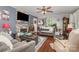 Bright and spacious living room features a stone fireplace, hardwood floors, and lots of decor at 106 Rainbow Sw St, Concord, NC 28025