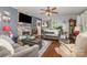 Bright and spacious living room features a stone fireplace, hardwood floors, and lots of decor at 106 Rainbow Sw St, Concord, NC 28025