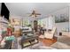 Comfortable living room with a fireplace, hardwood floors, and large windows at 106 Rainbow Sw St, Concord, NC 28025