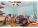Office with wood floors and desk, blue walls, white trim, and abundant storage at 106 Rainbow Sw St, Concord, NC 28025