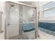 Bathroom shower with white tile, glass doors and blue accent towel at 106 Rainbow Sw St, Concord, NC 28025