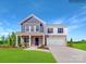 Beautiful two-story home with stone accents, a covered porch, and a well-manicured lawn at 1092 Old Trade St, Edgemoor, SC 29712