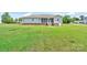 Backyard view of the home featuring a screened patio, grassy lawn, and mature trees at 110 Carol Lyn Dr, Kings Mountain, NC 28086