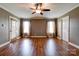 Spacious living room with hardwood floors, a ceiling fan, and large windows, perfect for Gathering gatherings at 110 Carol Lyn Dr, Kings Mountain, NC 28086
