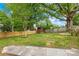 Large, fenced backyard features a shed, plenty of green space, and mature trees at 1104 Venus St, Kannapolis, NC 28083