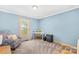 Bright bedroom featuring blue walls, a patterned chair, and a comfortable workstation at 1104 Venus St, Kannapolis, NC 28083