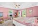 Cozy bedroom featuring a charming quilt, ceiling fan, and ample natural light at 1104 Venus St, Kannapolis, NC 28083
