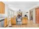 Open kitchen with stainless steel appliances, wood cabinets, and connection to dining area at 1104 Venus St, Kannapolis, NC 28083