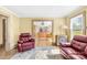 Inviting living room with wood floors, comfortable seating, and an open doorway to the kitchen at 1104 Venus St, Kannapolis, NC 28083