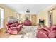 Warm living room featuring cozy furniture, neutral walls, and a brick fireplace at 1104 Venus St, Kannapolis, NC 28083