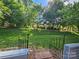 Spacious backyard with lush lawn and mature trees, perfect for outdoor activities at 11216 Carmel Chace Dr, Charlotte, NC 28226