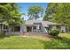 Backyard featuring a patio, dining area, and well-maintained grass at 11216 Carmel Chace Dr, Charlotte, NC 28226