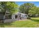 A well-maintained backyard features a quaint patio with outdoor seating and mature landscaping at 11216 Carmel Chace Dr, Charlotte, NC 28226