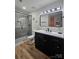 The modern bathroom features a frameless glass shower and black hardware at 11216 Carmel Chace Dr, Charlotte, NC 28226