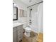 Updated bathroom featuring a gray vanity, modern fixtures, wood floors, and a shower with tub creating a relaxing retreat at 11216 Carmel Chace Dr, Charlotte, NC 28226
