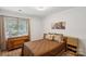 Comfortable bedroom with hardwood floors and a large window for natural light at 11216 Carmel Chace Dr, Charlotte, NC 28226