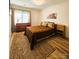 Cozy bedroom featuring wood floors, area rug, and natural light from the window at 11216 Carmel Chace Dr, Charlotte, NC 28226