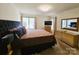 Cozy bedroom with a large bed, dresser, and window offering natural light at 11216 Carmel Chace Dr, Charlotte, NC 28226