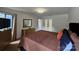 Well-lit bedroom with a dresser, mirror, and a partial view of a large bed at 11216 Carmel Chace Dr, Charlotte, NC 28226