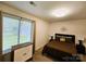 Comfortable bedroom with natural light, neutral decor, and modern furnishings at 11216 Carmel Chace Dr, Charlotte, NC 28226