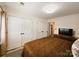 Comfortable bedroom featuring closets, tv and a brown patterned quilt at 11216 Carmel Chace Dr, Charlotte, NC 28226