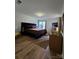 Bright bedroom with a large bed, wooden floor, and modern furniture arrangement at 11216 Carmel Chace Dr, Charlotte, NC 28226