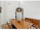 Bright dining room featuring a modern chandelier, hardwood floors, and ample natural light at 11216 Carmel Chace Dr, Charlotte, NC 28226