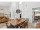 A dining room with a large wooden table and chairs, and a view into the living room at 11216 Carmel Chace Dr, Charlotte, NC 28226