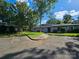 Inviting gray townhome with manicured lawn, mature trees, and ample parking at 11216 Carmel Chace Dr, Charlotte, NC 28226