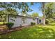 A well-maintained home with gray siding, green lawn, and mature trees at 11216 Carmel Chace Dr, Charlotte, NC 28226