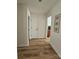Hallway featuring wood flooring and neutral walls, with doors leading to other rooms in the home at 11216 Carmel Chace Dr, Charlotte, NC 28226