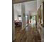 Open hallway with wood floors leading to dining area and living room with sliding glass doors at 11216 Carmel Chace Dr, Charlotte, NC 28226
