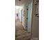 Inviting hallway with wood flooring, decorative light fixtures, and views of the home's interior spaces at 11216 Carmel Chace Dr, Charlotte, NC 28226