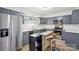 Contemporary kitchen with stainless steel appliances, a kitchen island, and stylish gray cabinets at 11216 Carmel Chace Dr, Charlotte, NC 28226