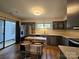 Modern kitchen featuring stainless steel appliances, breakfast bar, and sliding glass doors to patio at 11216 Carmel Chace Dr, Charlotte, NC 28226
